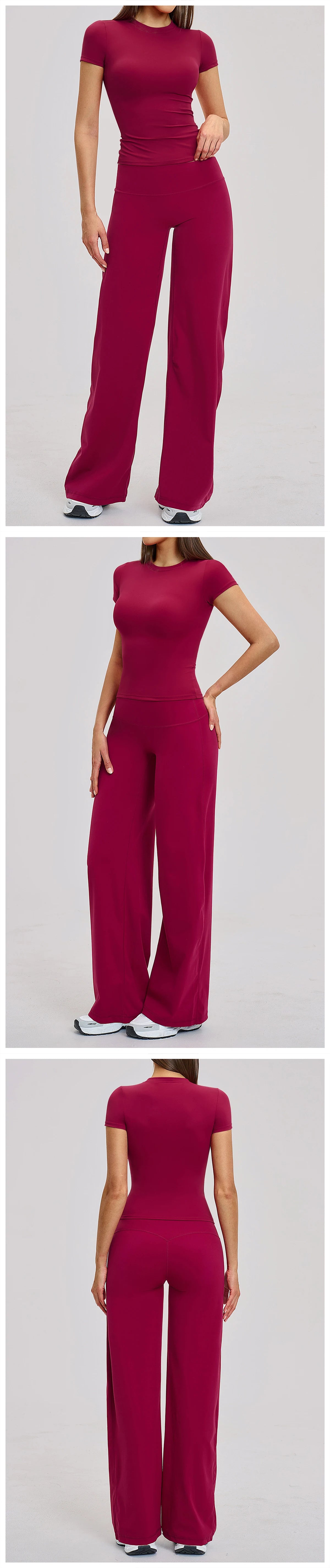 A woman models a deep magenta women's premium fitness tracksuit in a fitted long-sleeved top and matching trousers.