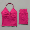 A bright pink women's seamless fitness set consisting of a cropped top and long sleeves.