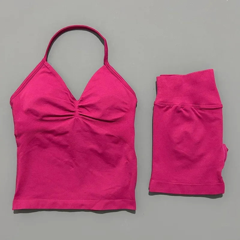 A bright pink women's seamless fitness set consisting of a cropped top and long sleeves.
