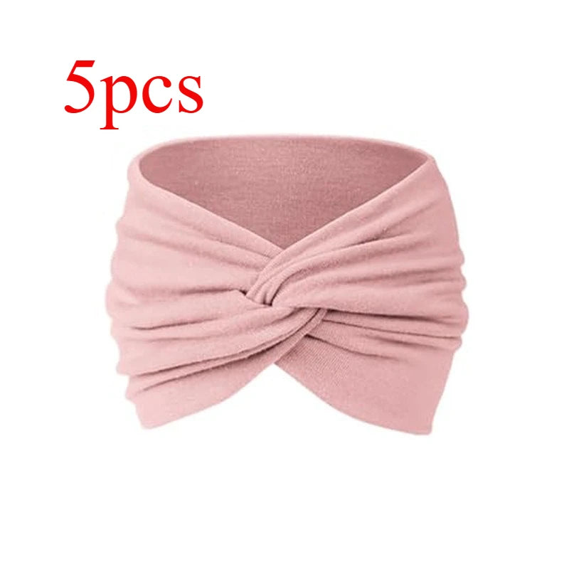 Cinco diademas de tela rosa atadas en un nudo para fitness y yoga
