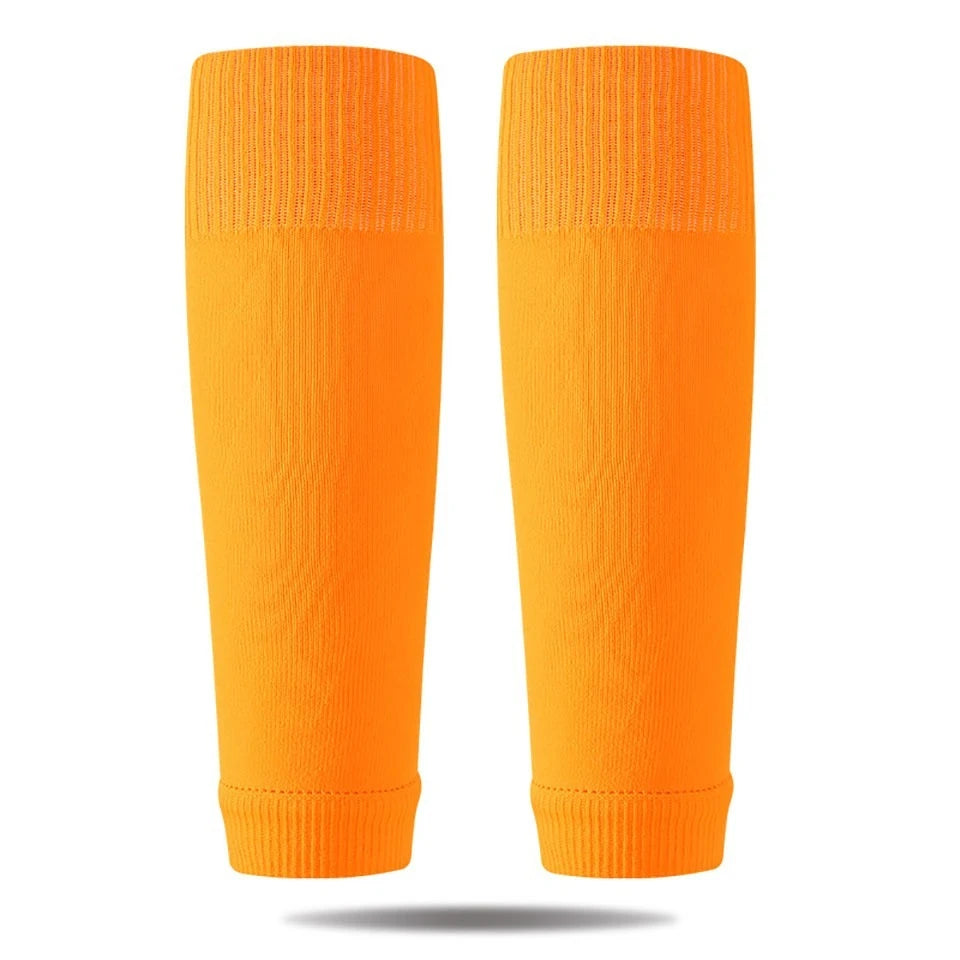 A pair of bright orange professional compression soccer and sports sleeves.