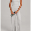 A woman models a light gray high-waist yoga and fitness tracksuit set with black headphones.