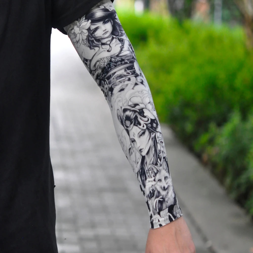 Close-up of a person's arm wearing black and white floral tattoo sleeves for sun protection.