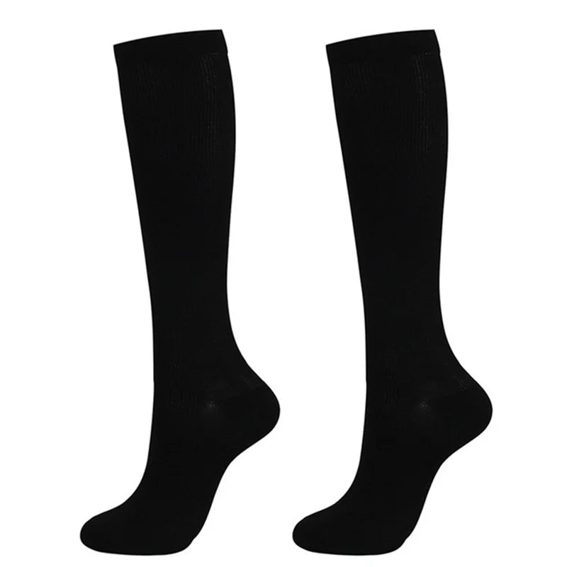 A pair of black medical grade compression socks for veins and circulation.