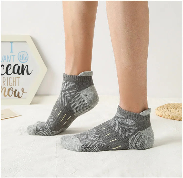 Gray athletic mesh ankle socks displayed on a person's lower leg.