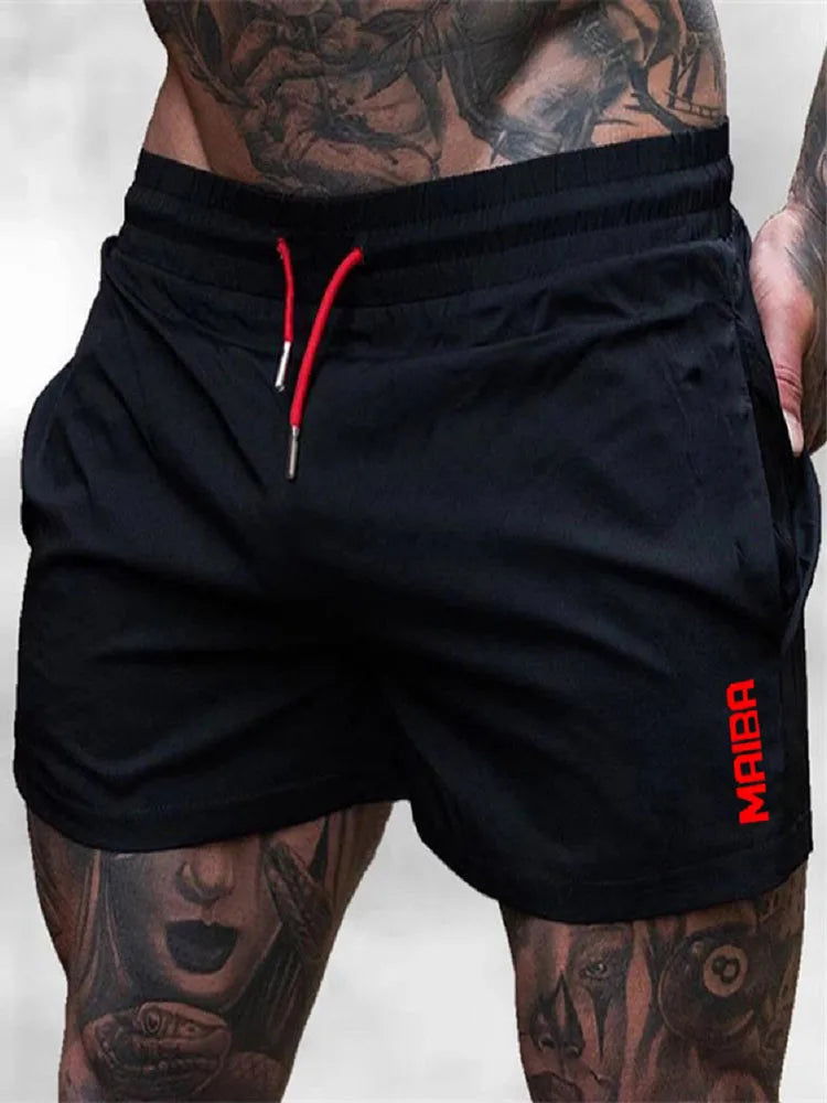 Black men's stretch performance drawstring shorts worn by a model with visible tattoos.
