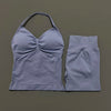 A light gray women's seamless fitness set consisting of a cropped top and matching capri-length bottoms.