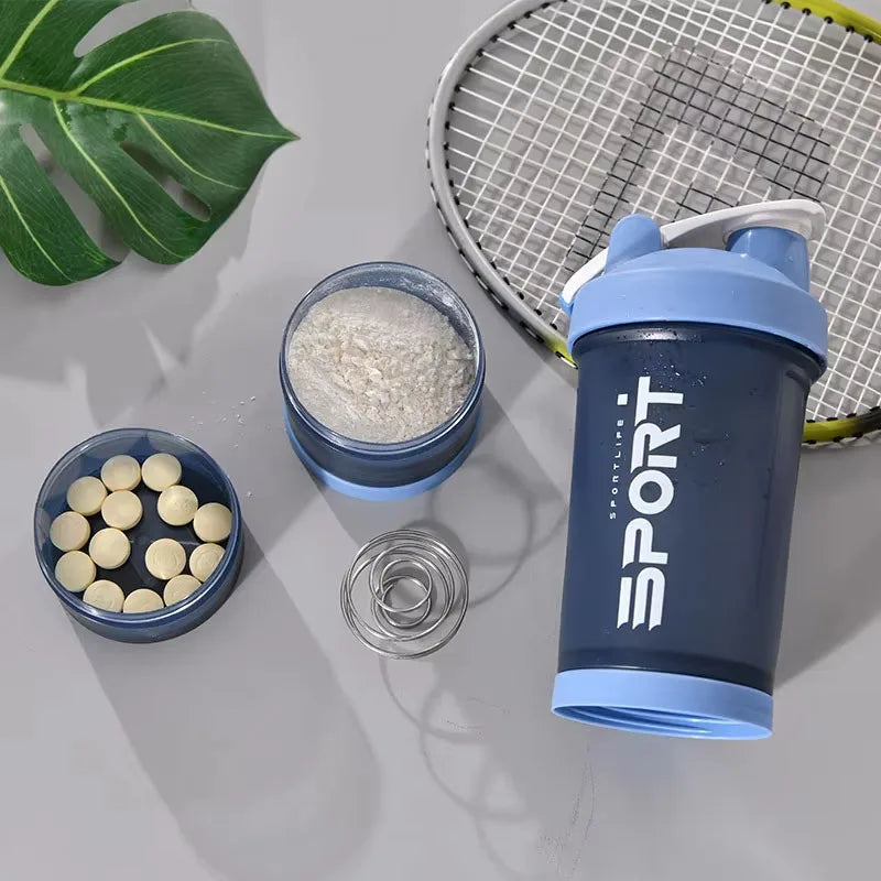 A dark blue sports shaker bottle with a handle is shown next to a mesh tennis racket and a bowl of white powder.