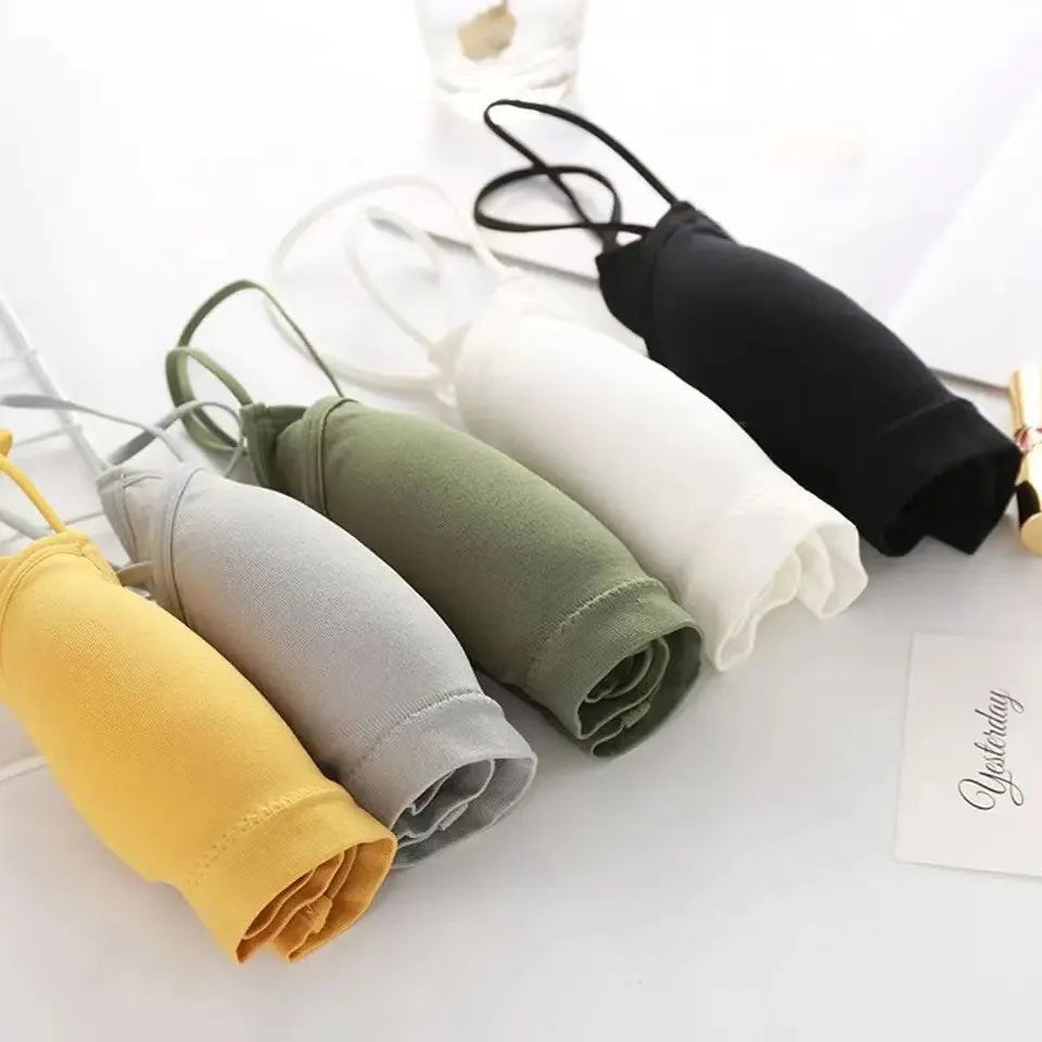 A collection of women's cross strap sports bras in various colors including black, gray, olive green, white, and yellow.
