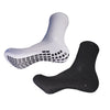 A pair of white and black athletic grip socks shown from the side.
