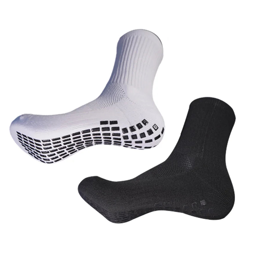 A pair of white and black athletic grip socks shown from the side.