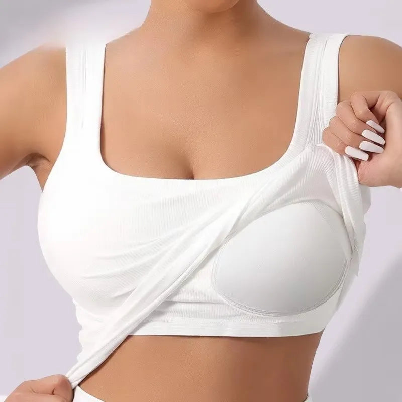 White racerback padded tank top worn by a woman, showing the front view of the garment.