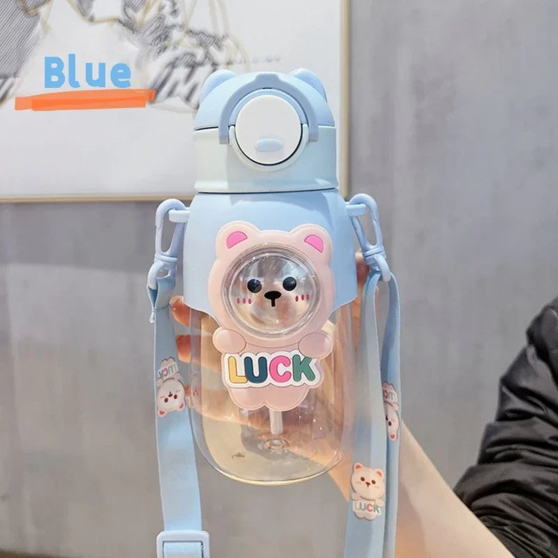 A light blue leak-proof water bottle shaped like a pink cartoon bear with the word LUCK on the front.