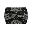 Black fabric with white paisley print tied into a wide knotted headband