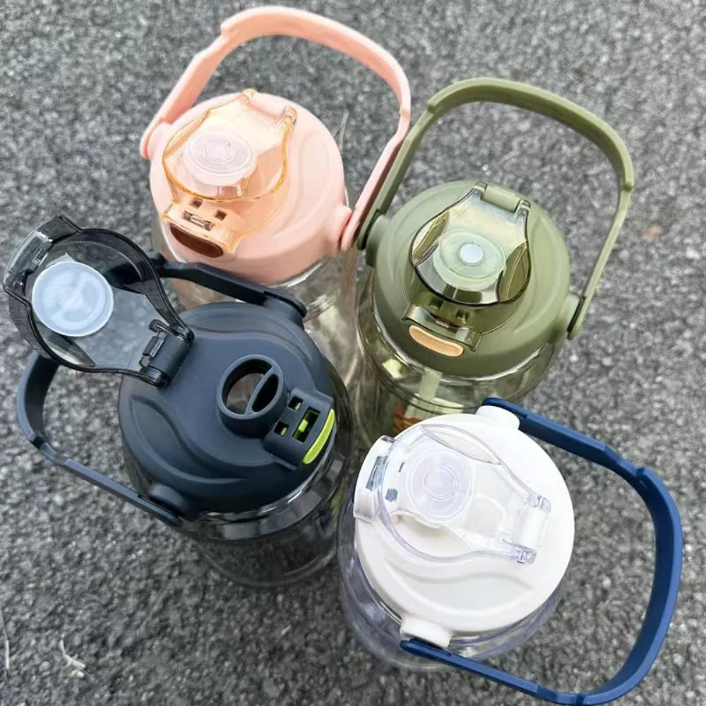 A collection of four insulated sports water bottles in pink, green, black, and white plastic.