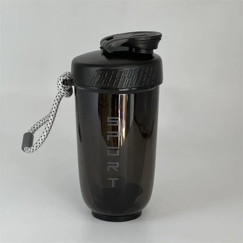 A black 600ml blender shaker bottle with a sports cap and attached lanyard.
