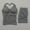 A gray women's seamless backless fitness set consisting of a cropped top and matching leggings.