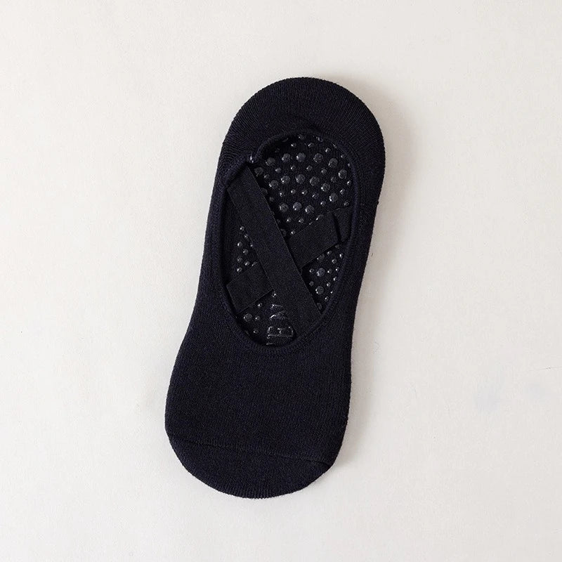 Black non-slip yoga and gym socks featuring silicone grip on the sole.