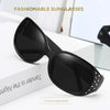 Black diamond-inlaid sunglasses displayed on a white surface with a light background.