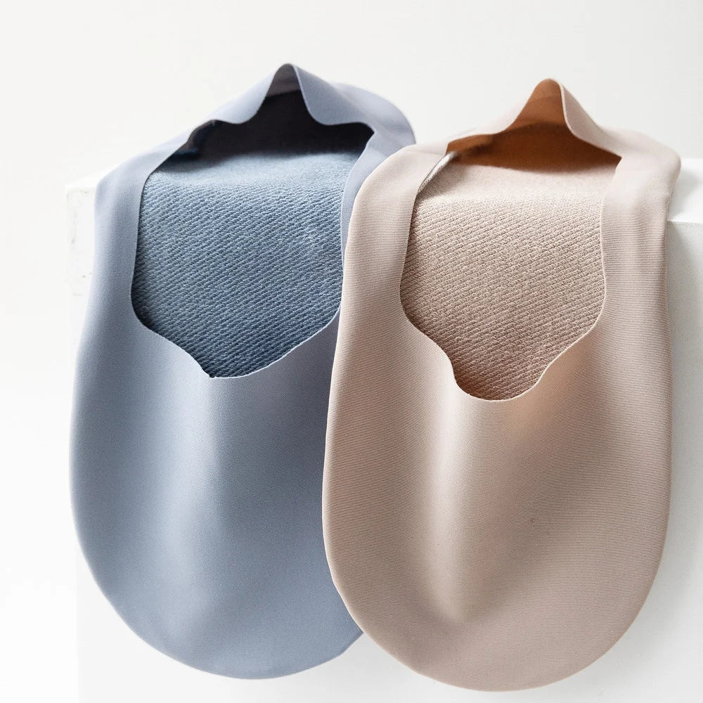 A pair of men's invisible boat socks in light blue and beige colors shown side by side.
