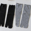 Pair of black and gray knit crew socks with ruffle cuffs