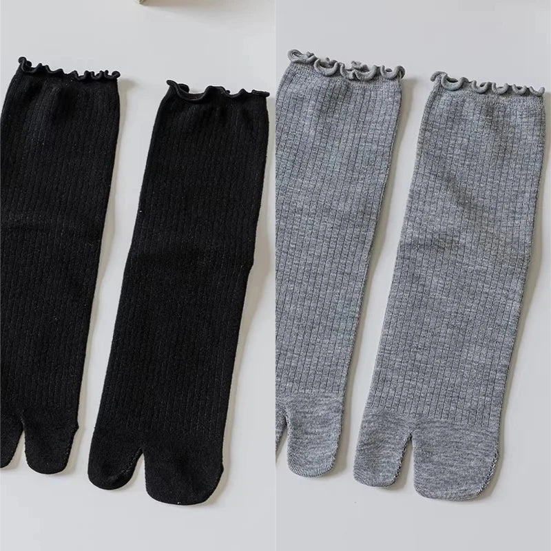 Pair of black and gray knit crew socks with ruffle cuffs