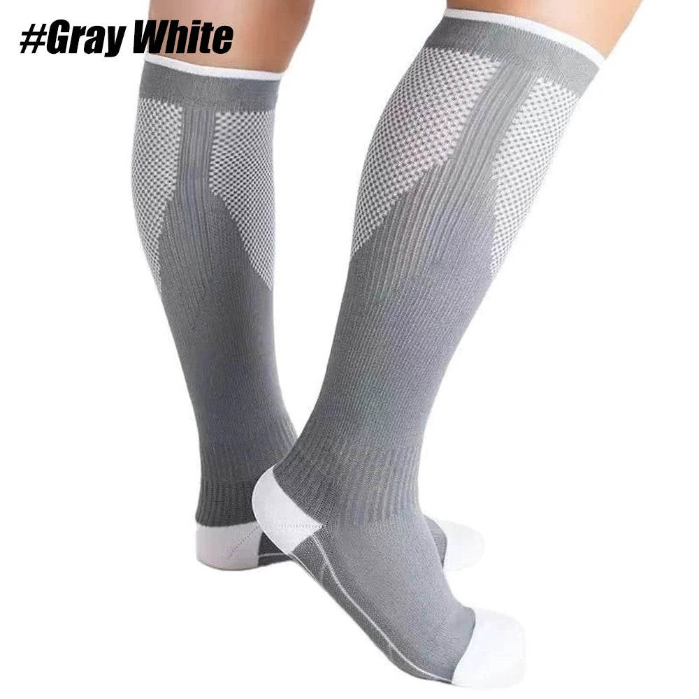 Gray white compression socks worn on a leg, showing the textured knit and cuff details.