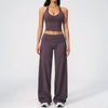 A woman wearing a dark purple women's premium fitness tracksuit top and matching pants.