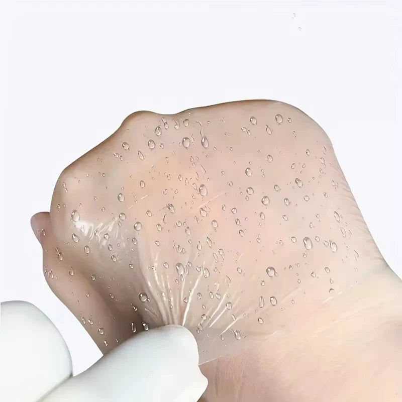 A hand is applying transparent self-adhesive finger protection tape to the fingertip.