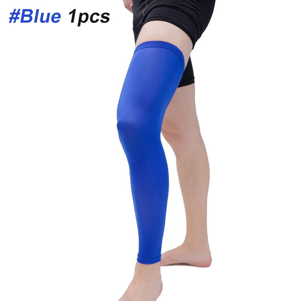 A person is wearing a royal blue compression leg sleeve on their lower leg.