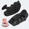 A black silicone gym and weightlifting grip glove is shown next to a hand.