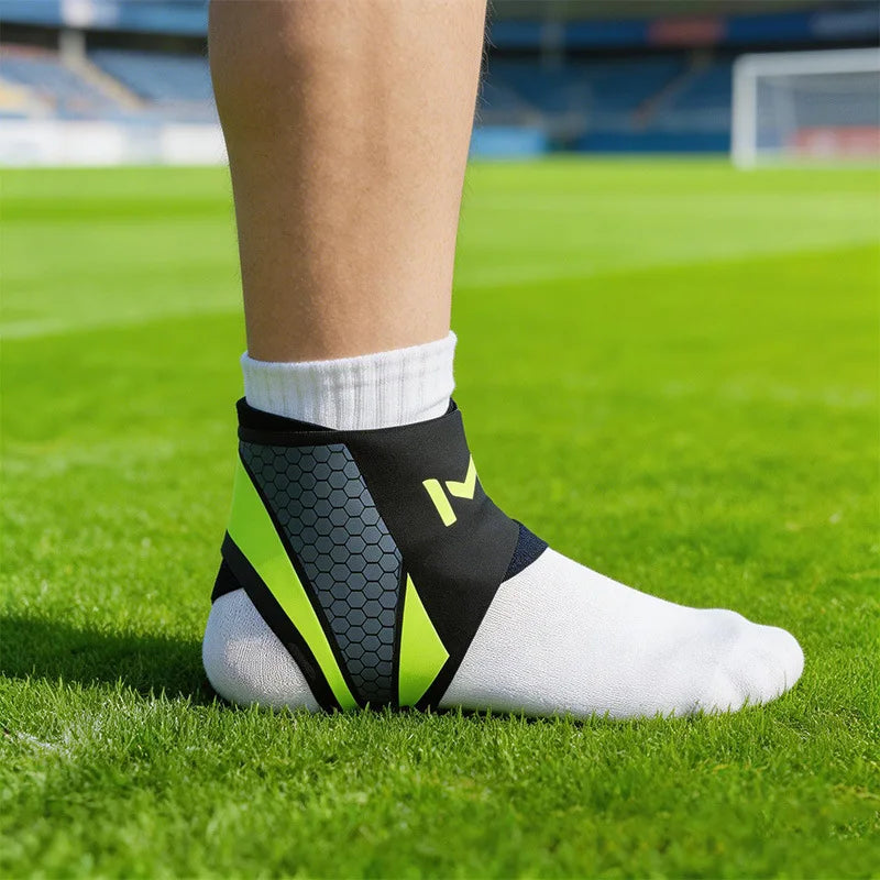 A close-up of a person's lower leg wearing a black and neon yellow knit ankle brace on a green sports field.