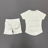 White seamless yoga set for women featuring a short sleeve top and workout leggings