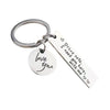 A silver metal keychain with a circular tag engraved with the words I love you and a rectangular tag engraved with Drive safe
