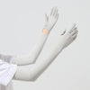 A close-up of a light gray UPF 50+ sun protection arm sleeve worn on an arm.