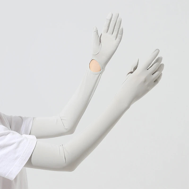 A close-up of a light gray UPF 50+ sun protection arm sleeve worn on an arm.