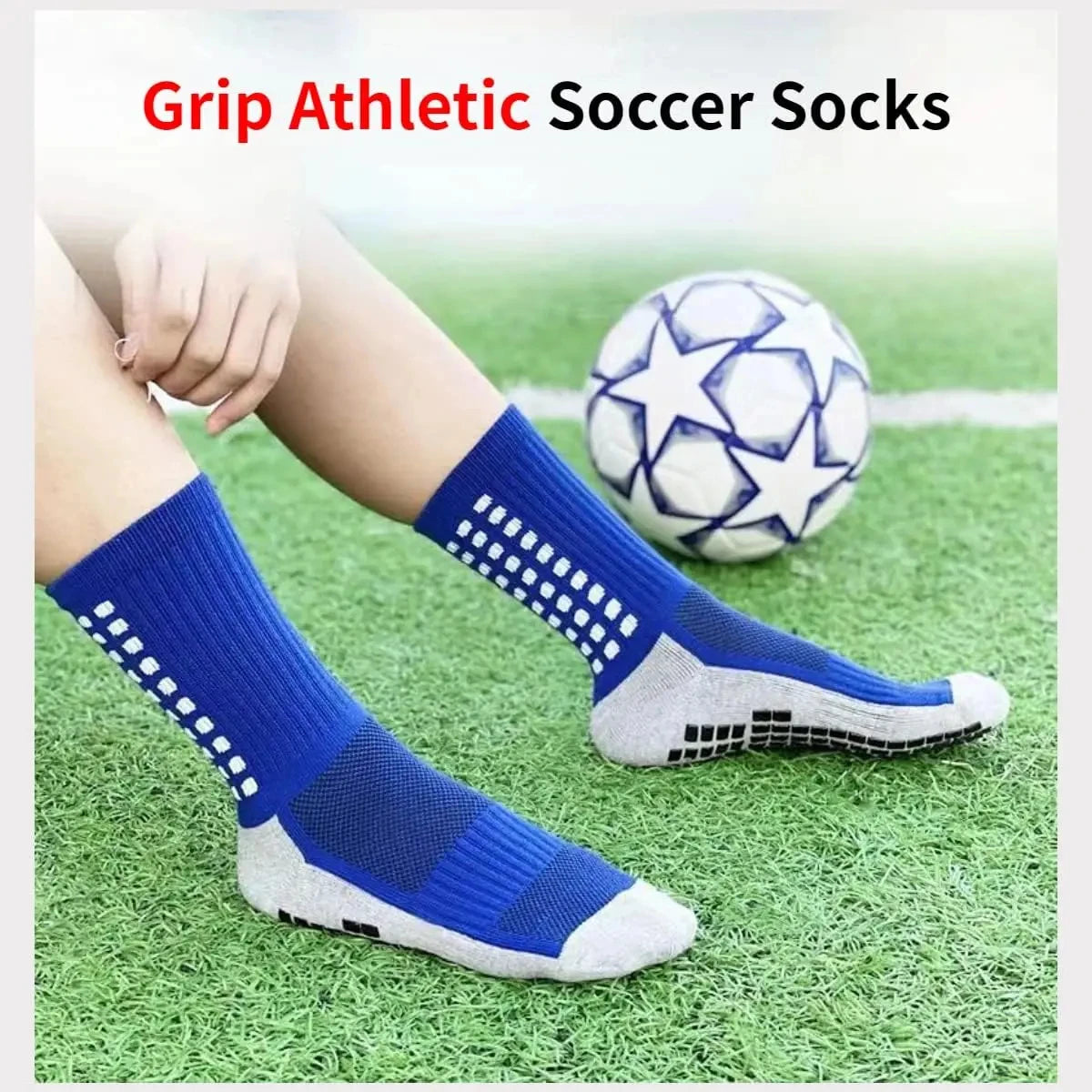 A pair of blue and gray athletic soccer socks lying on green grass next to a soccer ball.
