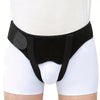 Black hernia support belt worn around the abdomen of a person wearing white shorts.