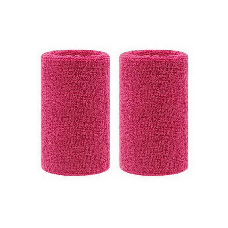 A pair of magenta dual sports wristbands for sweat absorption.