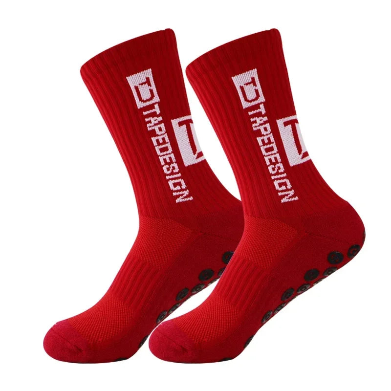 Pair of red anti-slip performance sports socks with white text and black dots