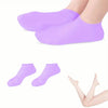 A pair of purple silicone moisturizing socks shown on a foot.