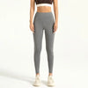 A woman wearing seamless gray high-waist yoga leggings and a cropped top, standing full length.