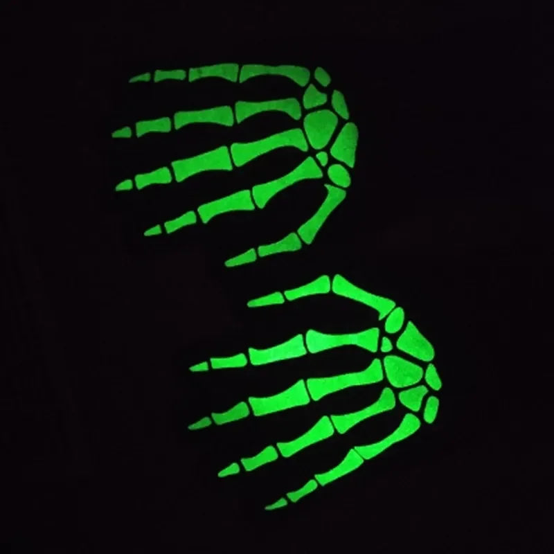 A glowing green handprint silhouette against a black background.