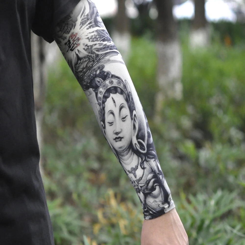 A close-up of a person's arm displaying intricate black and grey traditional style tattoos.
