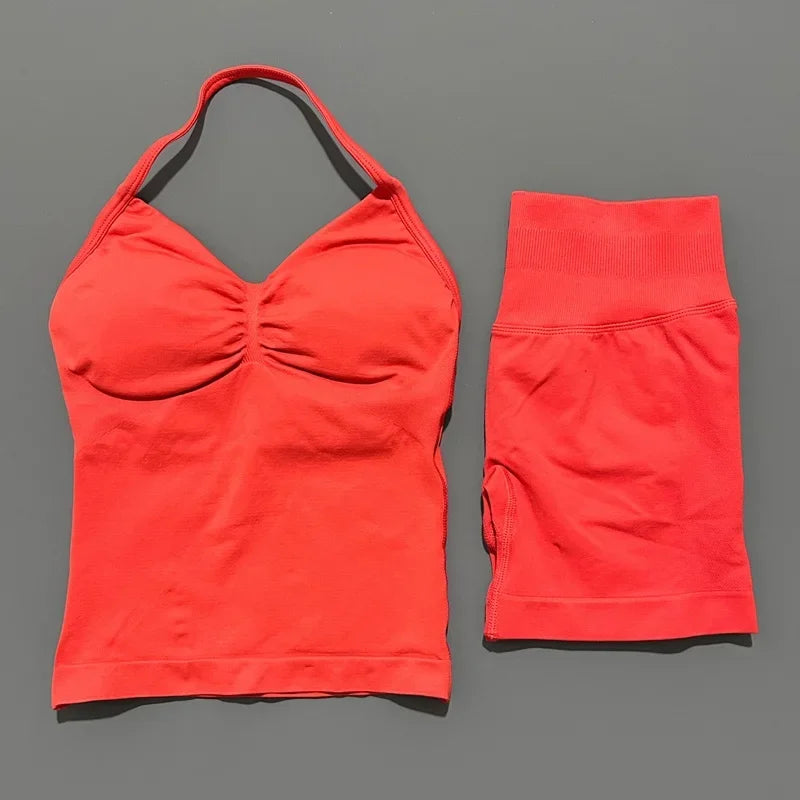 A bright red women's seamless fitness set consisting of a cropped top and matching leggings.