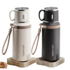 Two stainless steel insulated water bottles in beige and black with wooden stands
