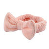 Pink microfiber spa headband and wristband set with a fluffy texture