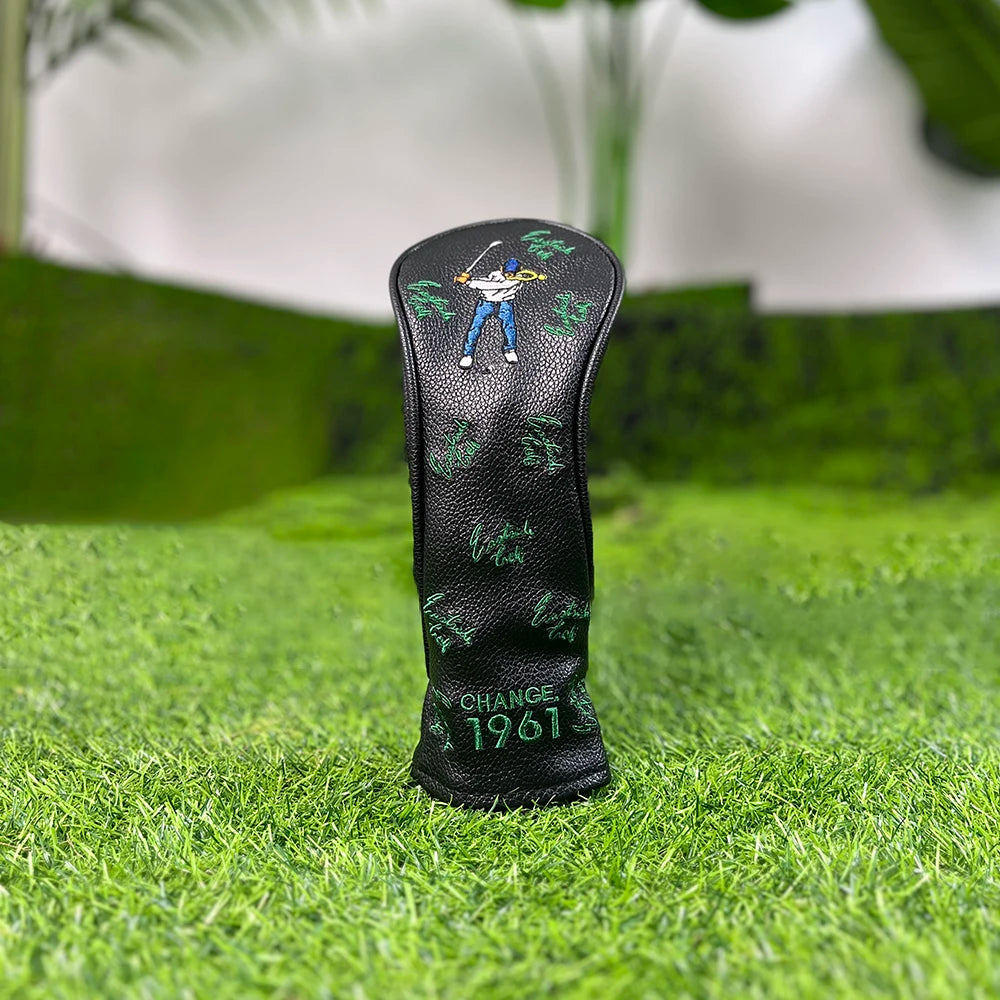 Black golf club head cover featuring a silhouette of a golfer and the text CHANGE 1961 placed on green grass.