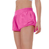 Pink women's high-waisted running shorts worn by a model.