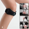 A black adjustable knee strap is shown being used to support the patella tendon area on a person's knee.